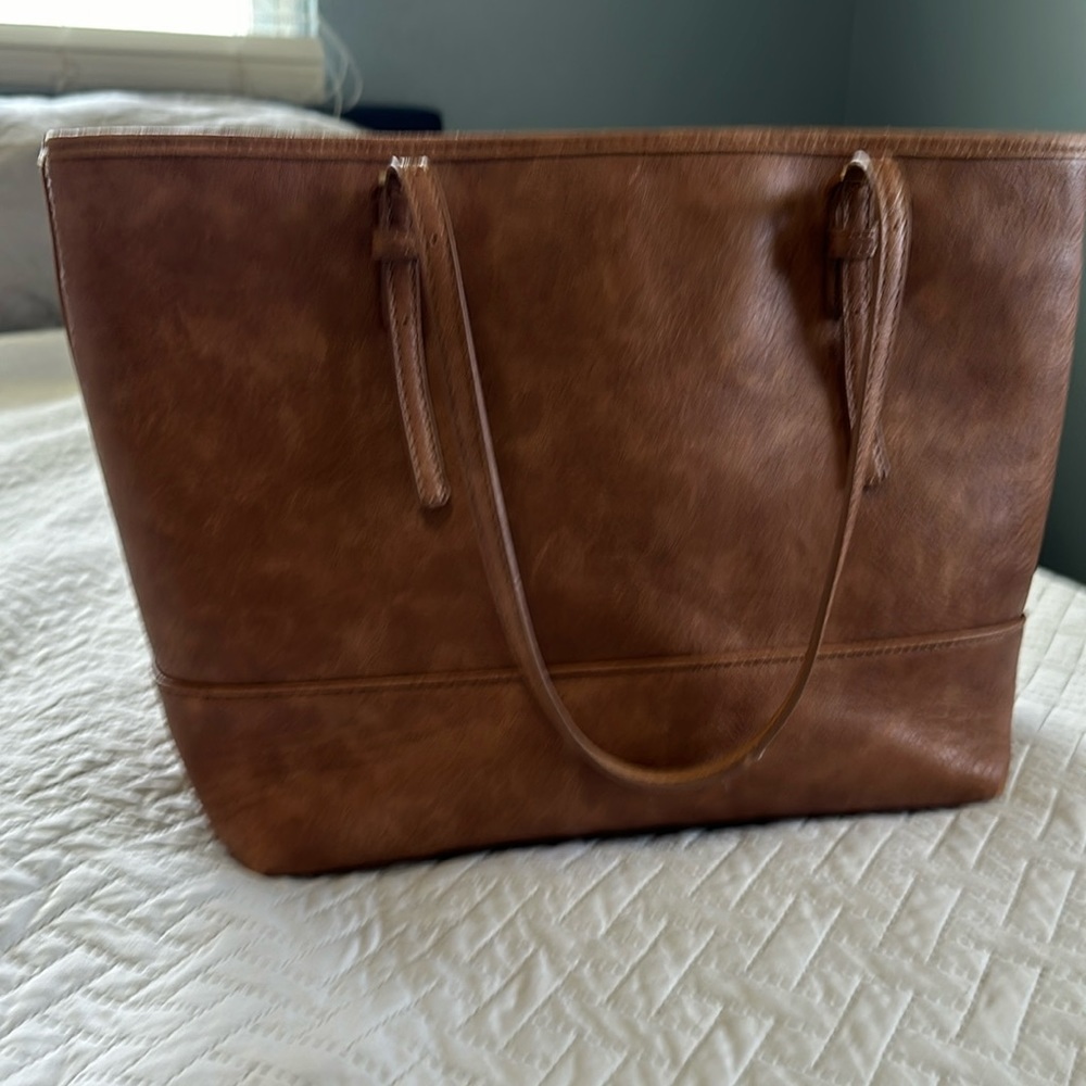 Tan work tote. Great condition. Black and white interior with laptop sleeve.